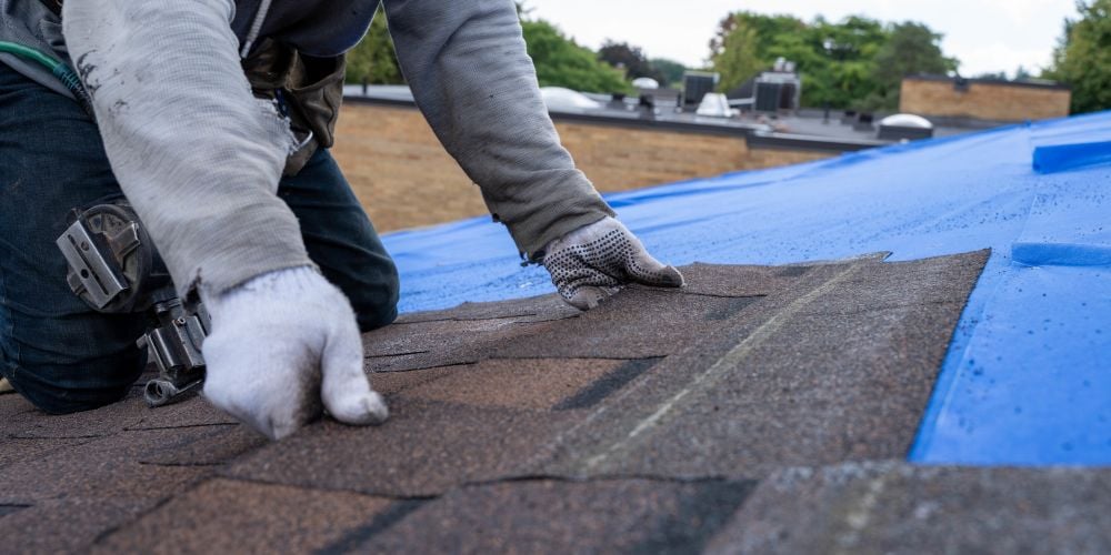 Roofing contractor installing a new roof.